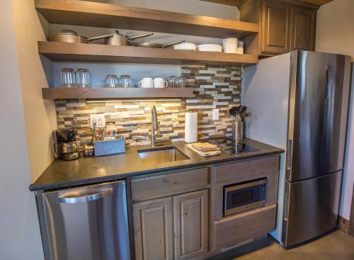 a kitchen with a sink and a refrigerator at Royal Gorge Cabins in Buckskin Joe