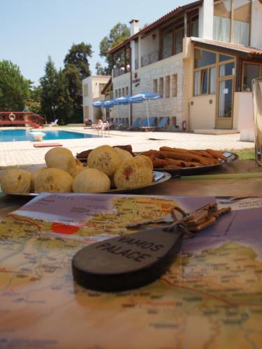 a bunch of food on a table with a pair of keys at Vamos Palace Apartments in Vamos
