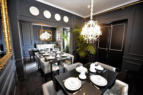 a dining room with tables and chairs and a chandelier at Angra Bed & Breakfast in Angra do Heroísmo