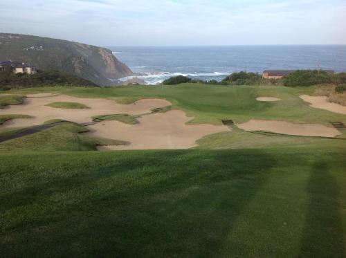 an aerial view of a golf course with the ocean at Pezula Golf House in Knysna