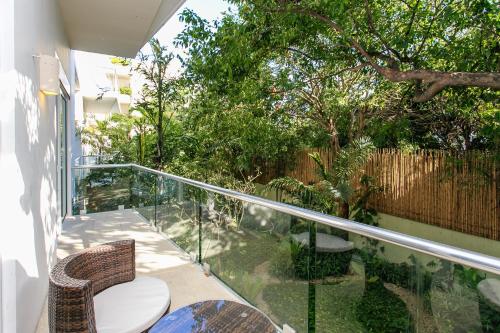 a balcony with a toilet and some trees at Papaya 15 Apartments in Playa del Carmen