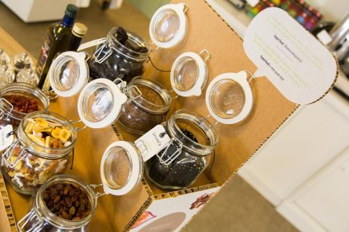 a table topped with jars of jam and nuts at Pace 1954 Hotel in Arco