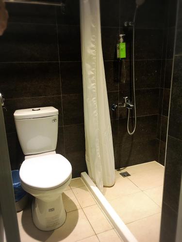 a bathroom with a toilet and a shower at Master Chitow Hostel in Kaohsiung