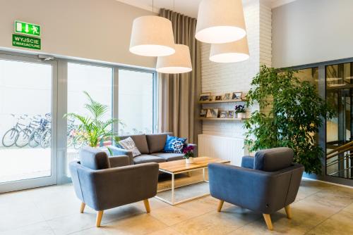 a lobby with two chairs and a couch and a table at Best Western Hotel Jurata in Jurata