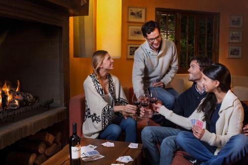 a group of people sitting on a couch in front of a fireplace at Hotel Santa Cruz Plaza in Santa Cruz