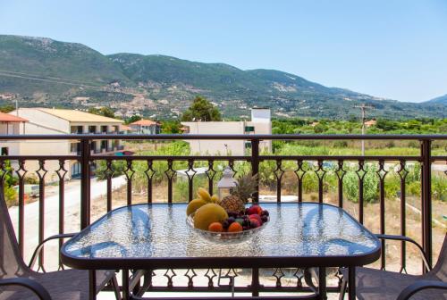 a bowl of fruit on a table on a balcony at Kavadias Apartments in Vasiliki