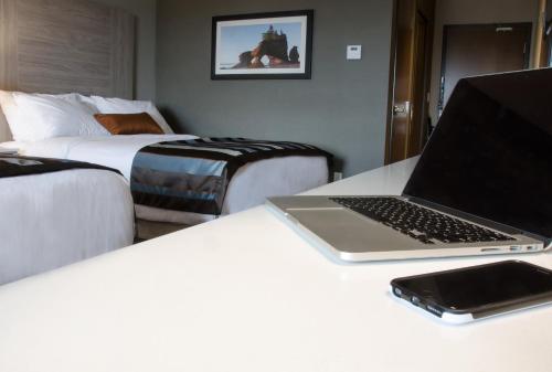 a laptop computer sitting on a desk in a hotel room at Wingate by Wyndham Dieppe Moncton in Moncton