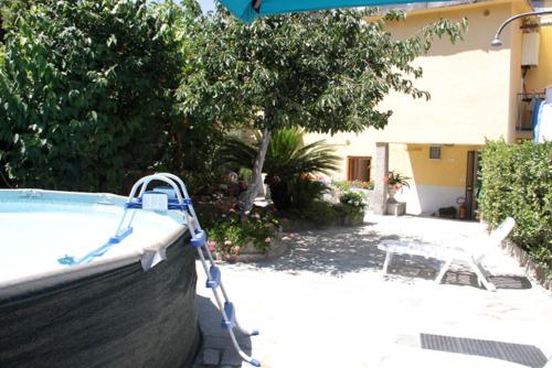 a pool with a table and a chair next to a house at carugio del fezzano in Fezzano
