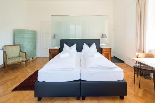 a bedroom with a large bed with two white pillows at Seehaus Familie Leifer in St. Wolfgang