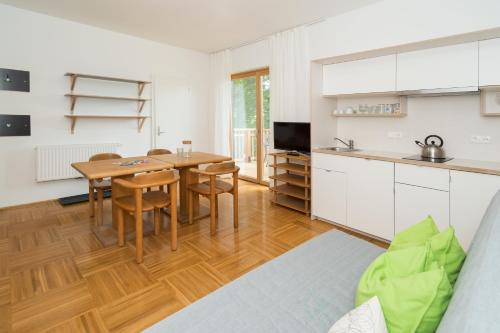 a kitchen and dining room with a table and chairs at Seehaus Familie Leifer in St. Wolfgang