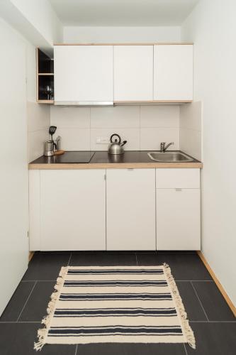 a kitchen with white cabinets and a sink at Seehaus Familie Leifer in St. Wolfgang
