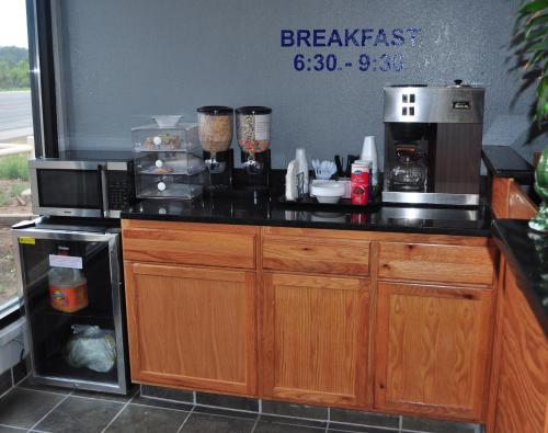 a kitchen with a counter top with a microwave at Bestway Inn in Ruidoso Downs