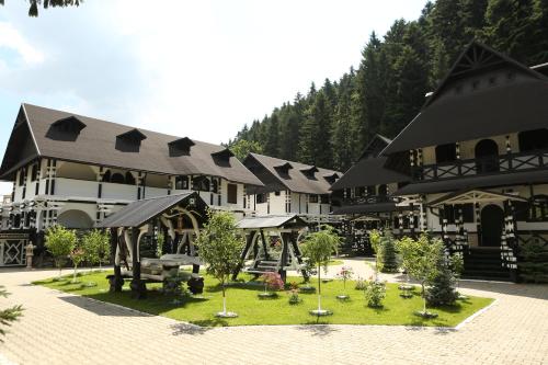 a large building with a garden in front of it at Complex Lions Bucovina in Voronet