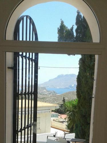 an open window with a view of a mountain at Todosol Dream in Águilas