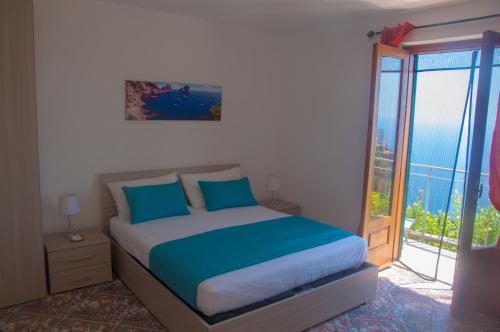 a bedroom with a bed and a large window at Casa Martina in Amalfi