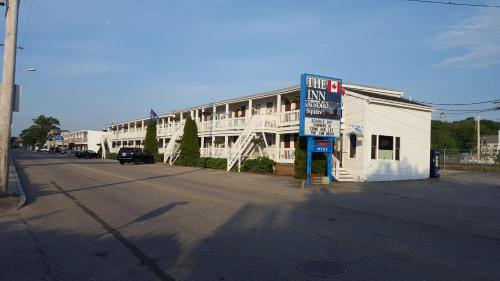 an empty street in front of a large white building at The Inn at Soho Square in Old Orchard Beach