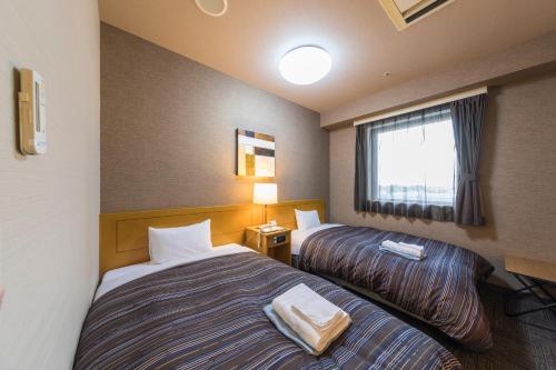 Lova arba lovos apgyvendinimo įstaigoje Route Inn Grantia Hanyu Spa Resort