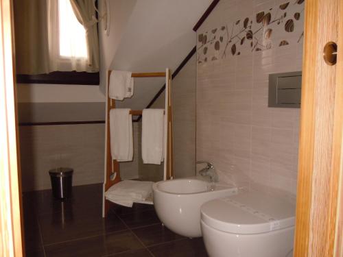 a bathroom with a toilet and a sink at Posada La Torre de los Isla & Spa in Beranga