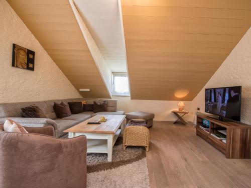 a living room with a couch and a tv at Südtiroler Stube in Seefeld in Tirol