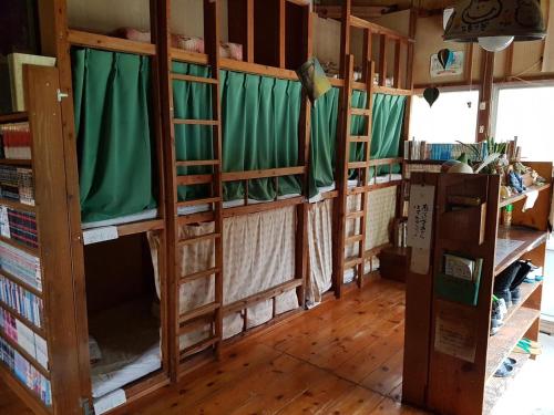 a room with a bunch of bunk beds at Tomarigi in Yakushima