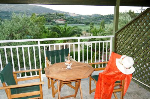 a wooden table and chairs on a porch with a view at Maria Studios in Keri