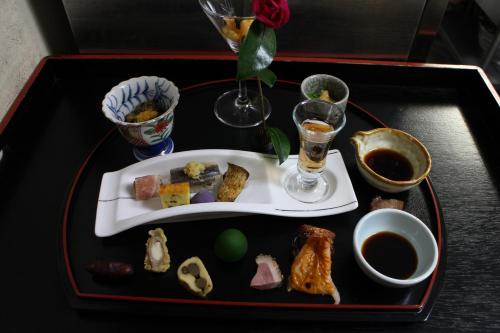 a tray with a plate of food on a table at Yufuin-Sanso Waremokou in Yufuin