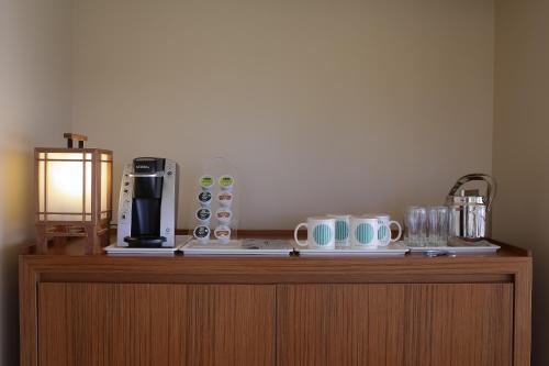 a table with a coffee maker and a blender on it at Guam Reef Hotel in Tumon