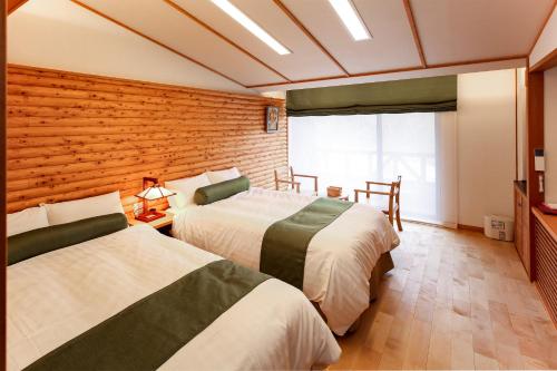 Ένα ή περισσότερα κρεβάτια σε δωμάτιο στο Hotel Fuki no Mori