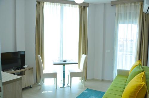 a living room with a couch and a table with chairs at Ambassador & Ambassador Lux Apartments in Ulcinj