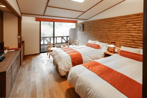 Postel nebo postele na pokoji v ubytování Hotel Fuki no Mori