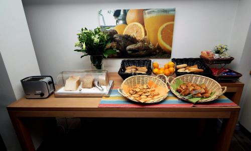 a table with three baskets of food on it at Trip Inn Eden Antwerpen in Antwerp