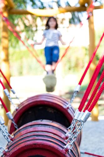 a young girl is riding on a swing at Hotel Vineyard Inn - Szőlőskert in Nagykanizsa