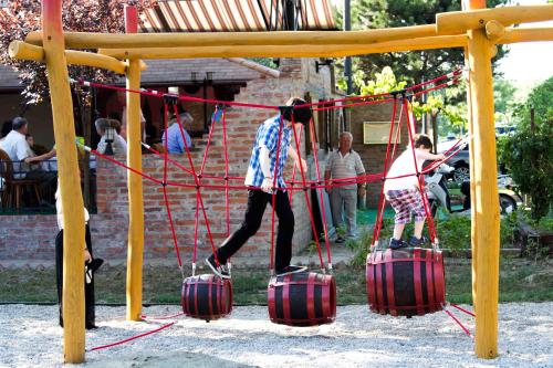 two people are playing on a playground with suitcases at Hotel Vineyard Inn - Szőlőskert in Nagykanizsa