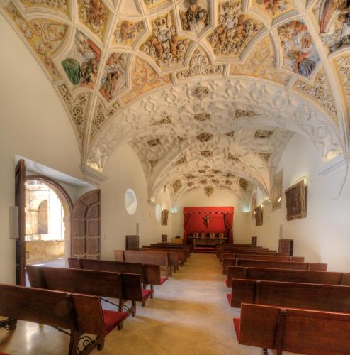 an empty church with a ceiling with paintings on it at Hotel Real Colegiata San Isidoro in León