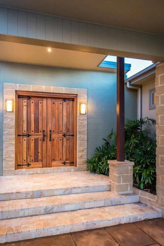 a front door of a house with stairs at Blue Cliff Retreat in Pokolbin