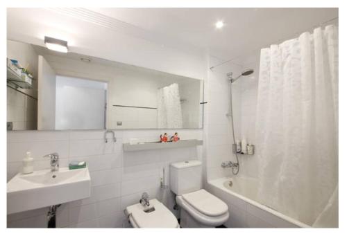 a bathroom with a toilet and a sink and a shower at White Cozy Flat in Donostia in Donostia-San Sebastián