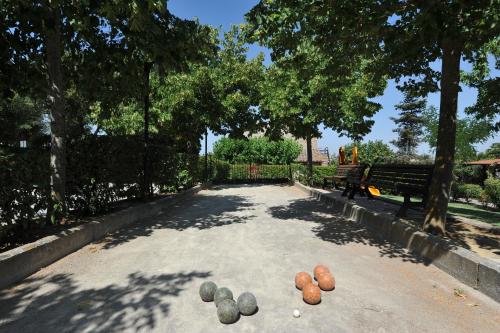 a park with rocks on the ground next to a bench at Agriturismo Tenuta Badia in Paciano