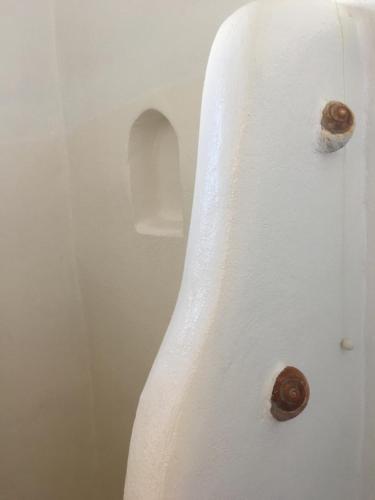a white bath tub with two buttons on it at Altana Boutique Hotel in Tinos Town