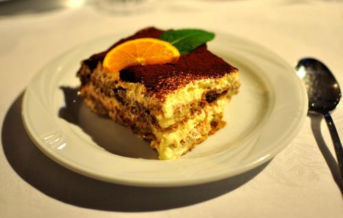 a piece of cake on a plate on a table at Bad St Isidor in Bolzano