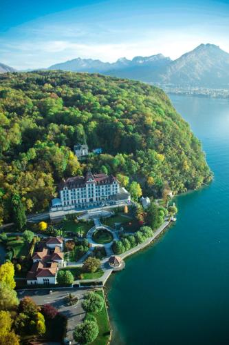 an aerial view of a resort on a lake at Le Palace De Menthon in Menthon-Saint-Bernard