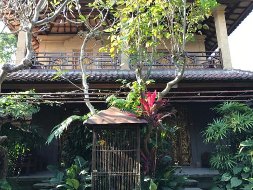 a building with a plant in front of it at Nirvana Pension in Ubud