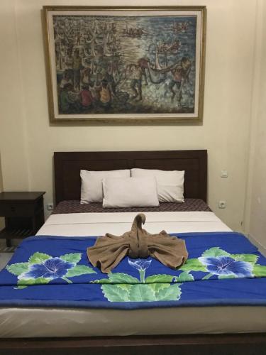 a bed with a towel on top of it at Nirvana Pension in Ubud