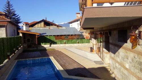 a swimming pool in a yard next to a house at Mineral 56 in Banya