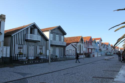 a street with houses and a person walking down the street at Beira Mar Loft in Aveiro