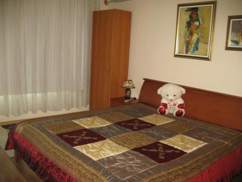 a teddy bear sitting on top of a bed at Guest House Slivek in Slivek
