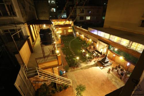 an overhead view of a building with a courtyard at night at Aarya Chaitya Inn in Kathmandu