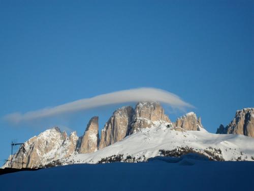 a lenticular cloud over a snow covered mountain at Villa Adria B&B in Canazei