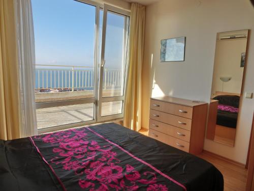 Schlafzimmer mit einem Bett und Meerblick in der Unterkunft Panoramic Sea View Apartment Crown, Pools and Beach, Sveti Vlas in Sweti Wlas