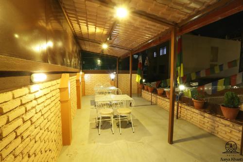 a patio with a table and chairs in a building at Aarya Chaitya Inn in Kathmandu