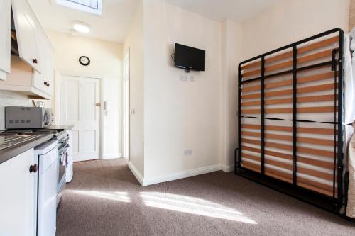 a kitchen with a refrigerator and a tv on the wall at Dublin Vacation Rentals in Dublin